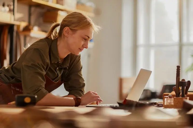woman checking broadband price on laptop